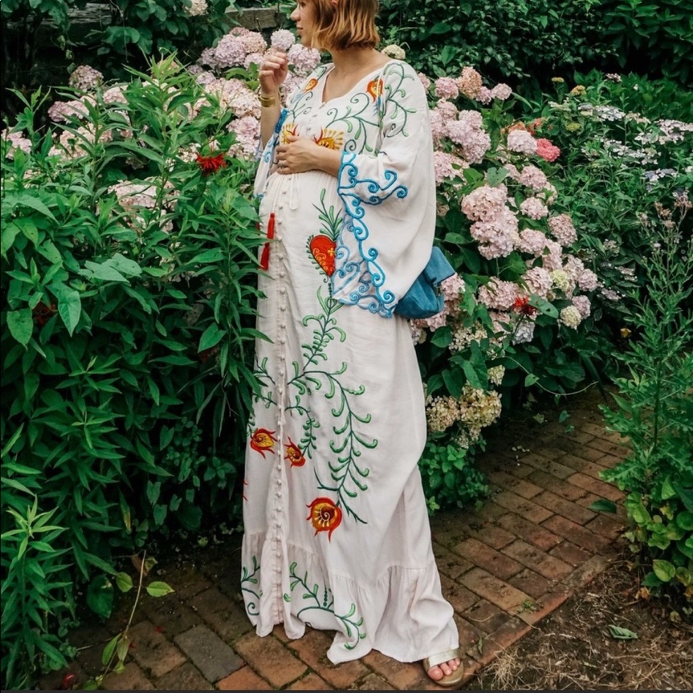 White maxi dress with colorful embroidery - for maternity pregnancy photos.